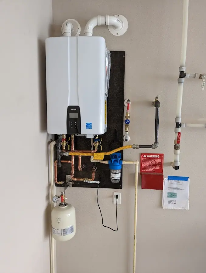 Professional plumber installing copper piping in a Kaufman home